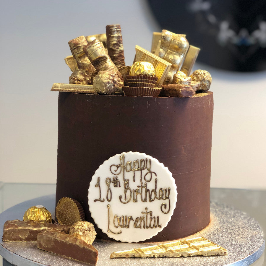 2-tier Wicked Chocolate cake iced in gold ganache decorate…